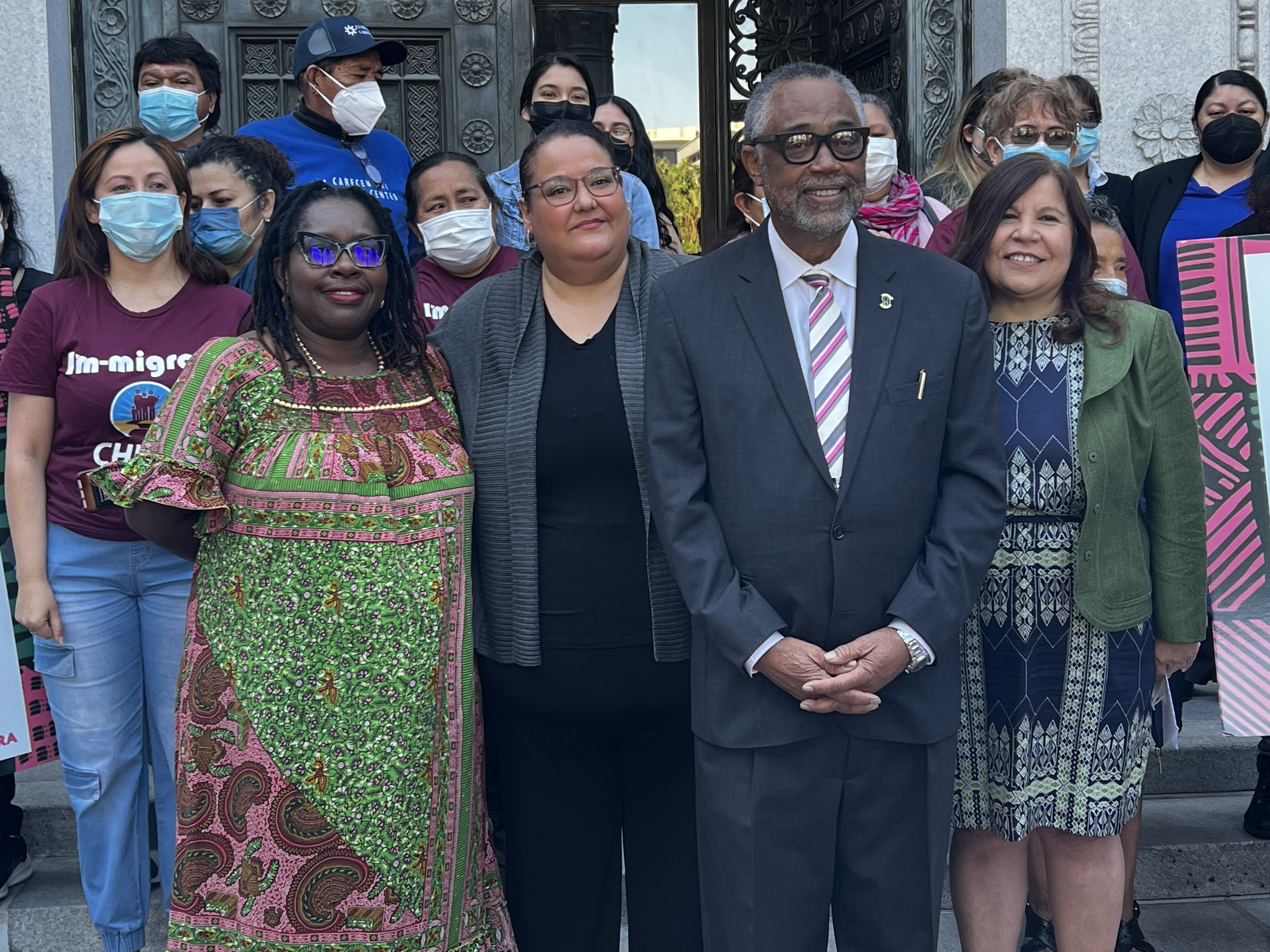 (l to r) BAJI Director Nana Gyamfi, CARECEN Director Martha Arevalo, Councilmember Curren Price Jr., and CHIRLA Director Angelica Salas pose with members at a ceremony to celebrate the allocation.